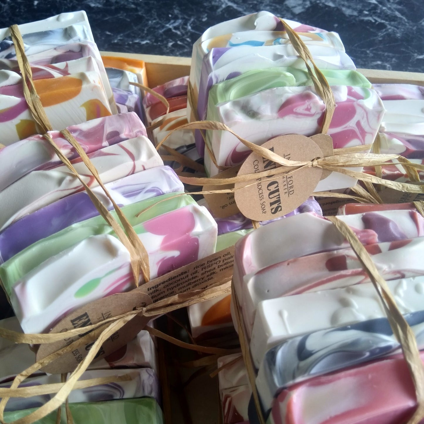 Colourful soap bars wrapped in paper with twine.